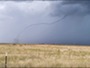 A tornado above an open field.