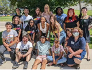 members of CSU fostering success program smiling beside a tree