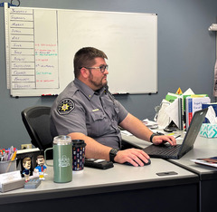Lt. Mark Pollard of the Weld County Sheriff's Office looking at his computer.