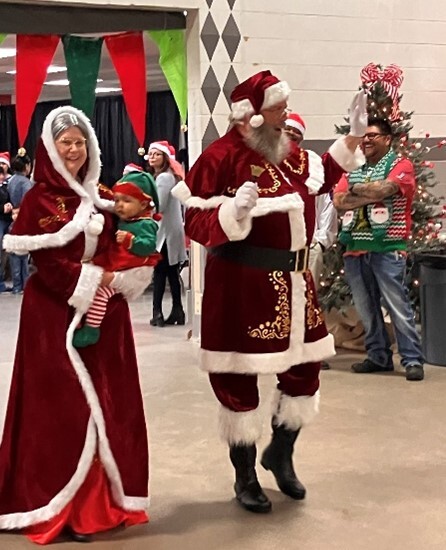 Another photo of Santa and Mrs. Claus with a baby elf