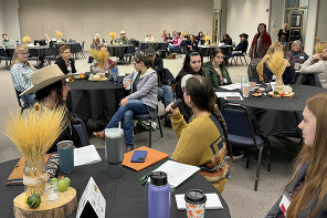 Women speaking and listening at the 2023 Women in Ag Conference.