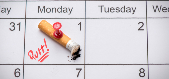 Cigarette butt tacked to quit date on calendar