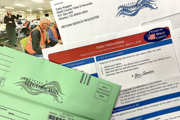 Various election materials such as a voting instructions, a ballot return envelope, and a news article about Carly Koppes.