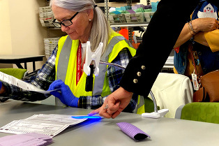 Weld County Clerk and Recorder Carly Koppes points at the GHOSTmark feature on a 2023 ballot.