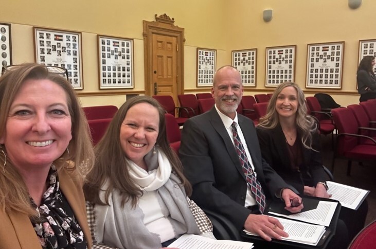 Human Services staff smiling and taking a selfie in a state court room.