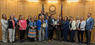 Nurses from throughout Weld County and WCDPHE staff standing with the Weld County Board of Commissioners.