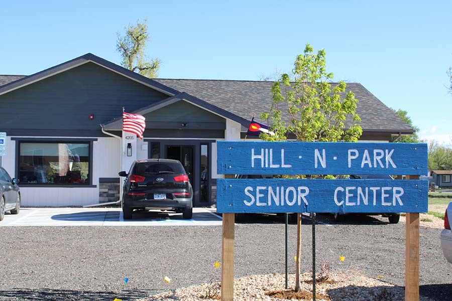 Photo of the entrance to the new Hill N Park senior center, featuring a blue sign with "Hill N Park Senior Center" written on it