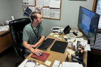 Fort Lupton Town Administrator Chris Cross sitting at his computer. 