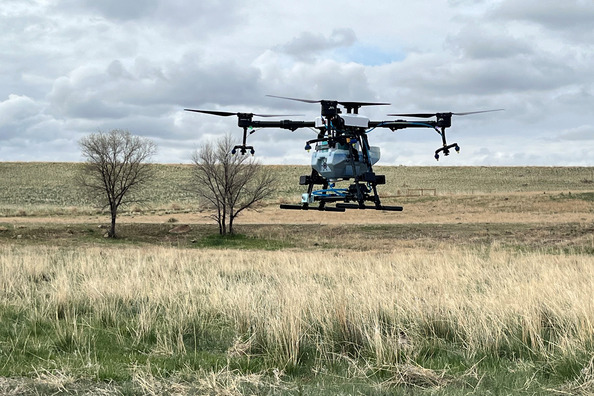 A drone rising above land.