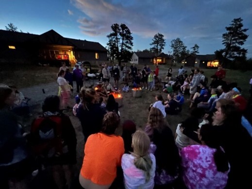 A group of kids sitting around a campfire