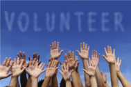 The word "volunteer" written above hands raised.