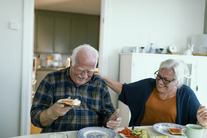 older couple eating and laughing 