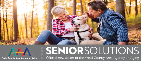 older couple with fall leaves 
