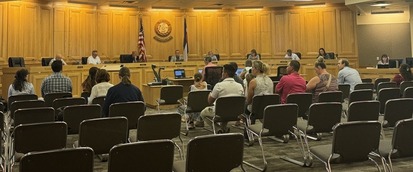 A planning commission meeting. The Weld County Planning Commission sits on the dais, with those in attendance seated.