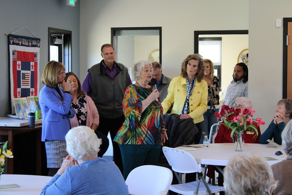 A woman speaking to people inside the Hill N' Park senior center.