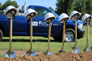 Shovels with a Roche Constructors truck in the background.