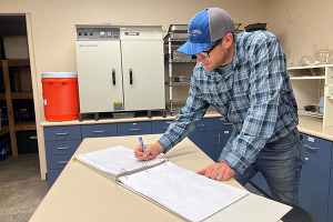 Ryan Axtman, Construction Inspection Supervisor for the Weld County Department of Public Works, writing in a log.