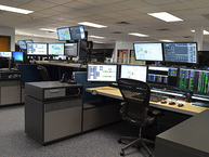 A station with a chair, computer and other equipment inside the Weld County Regional Communications Center.