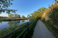 The Poudre River trail next to the Poudre River and some trees.