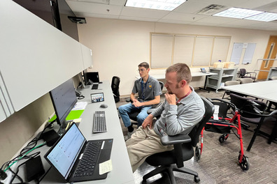Baker Geist sitting with Jaeden Nelson in the county's Joint Information Center.