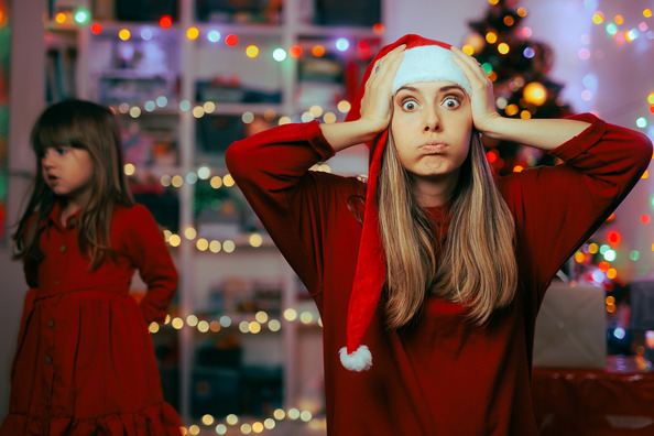 A mom looking shocked, stressed and tired during the holidays.