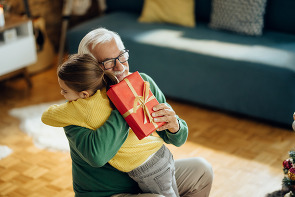 A grandfather embracing his granddaughter.