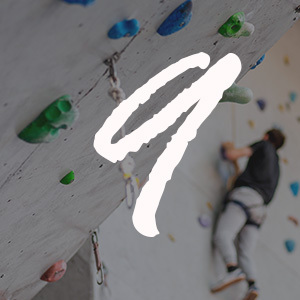 Man climbing up an indoor rock wall
