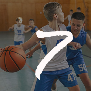 Junior basketball team is practicing game at indoor court.