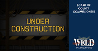 A construction sign with the words "under construction" written on it. 