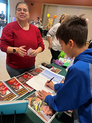 Isaac selling cookbooks