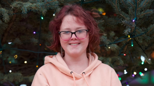 Tisha, a teenage girl with red hair and glasses.