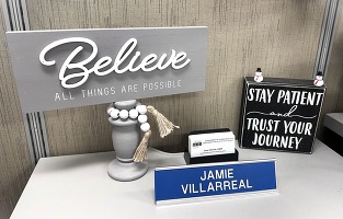 Motivational signs on Jaime Villarreal's desk next to his name plate