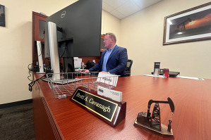 Weld County Oil and Gas Director Brett Cavanagh sitting at his desk looking at his computer.