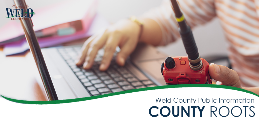 Hand on computer and emergency walkie talkie 