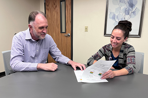 Doug Erler and Kim Peterson looking over an example of the SDM tool