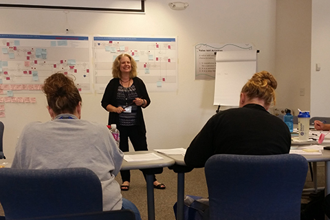 An IT staff member goes over the lean process with county employees.