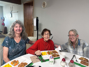 Three women enjoying a Friendly Fork meal