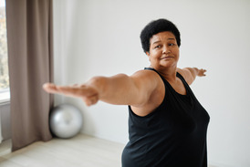 A woman stretching with her arms outstretched