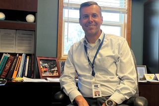 Platte Valley Superintendent Jeremy Burmeister sitting and smiling.