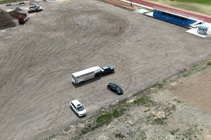 Drone footage, taken by a Platte Valley student, over a lot with cars and heavy trucks.