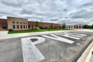 The front of Platte Valley High School with "PVHS" in the pavement.