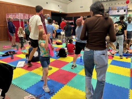 Children and camp counselors playing musical instruments