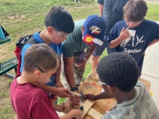 Group of young boys doing a woodworking project