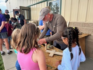 Young girls doing a woodworking project