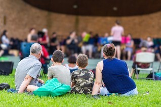 Family enjoying a summer concert in the park