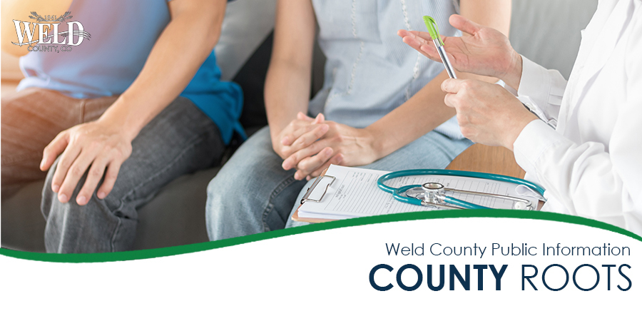 A man and woman speak to a doctor