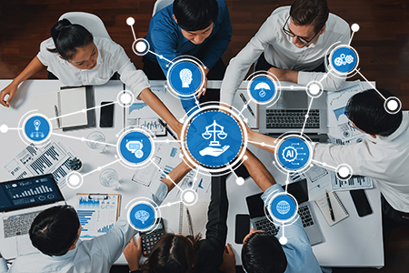 An overview image of people sitting around a table with their arms outstretched. Various technology-related icons are over the arms.