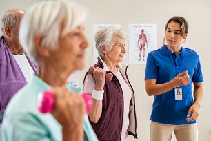Group of older adults lifting dumbbell weights
