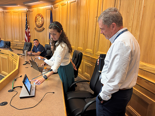 Esther Gesick shows the board of commissioners the new monitors that sit on the dais.