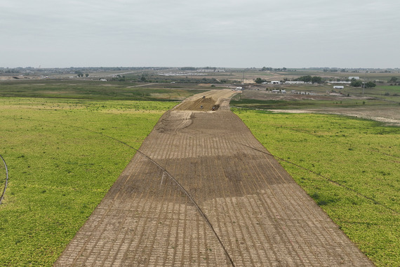 A dirt leg of the eventual roundabout planned near WCR 32. A geogrid sits on top of the dirt.